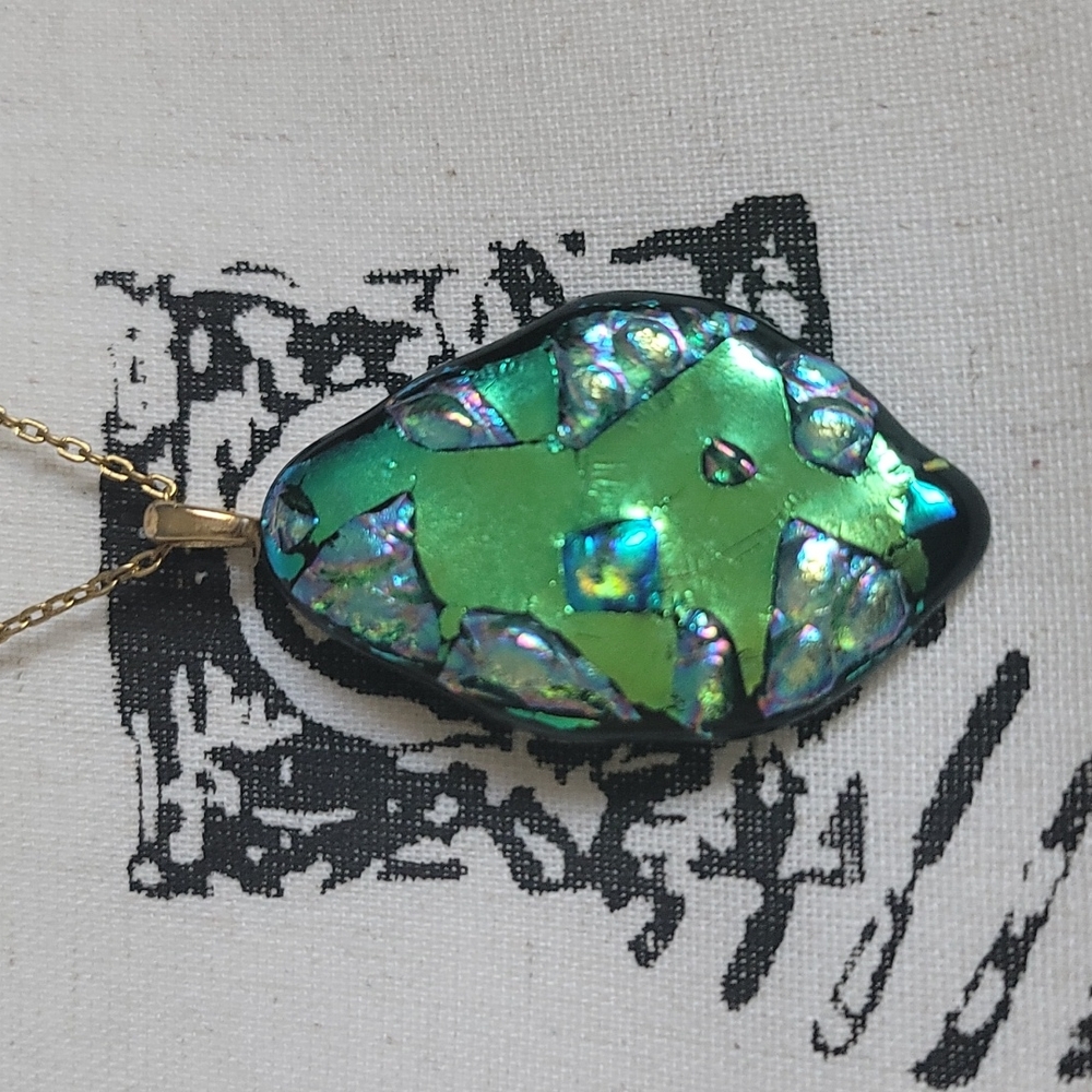 Green dichroic glass pendant with gold tone chain